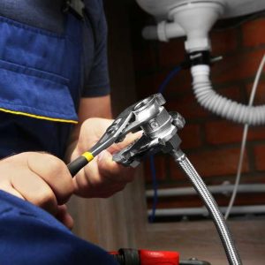 Hands,Of,Plumber,Connecting,Pipe,Union,To,Flexible,Hose,,Close