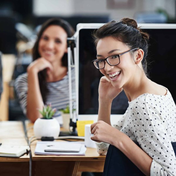 business-with-exuberance-portrait-of-young-office-workers-sitting-at-their-computers-